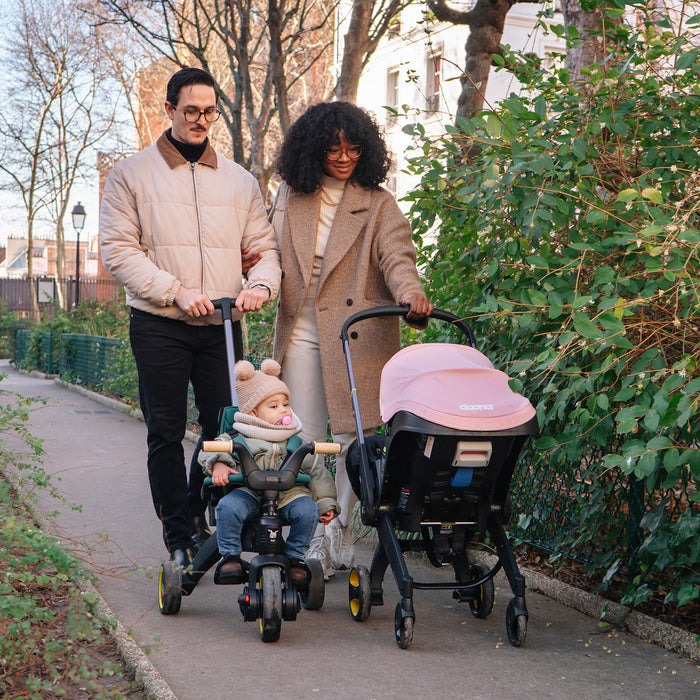 Family walking with Doona Stroller and Car Seat and Liki Trike