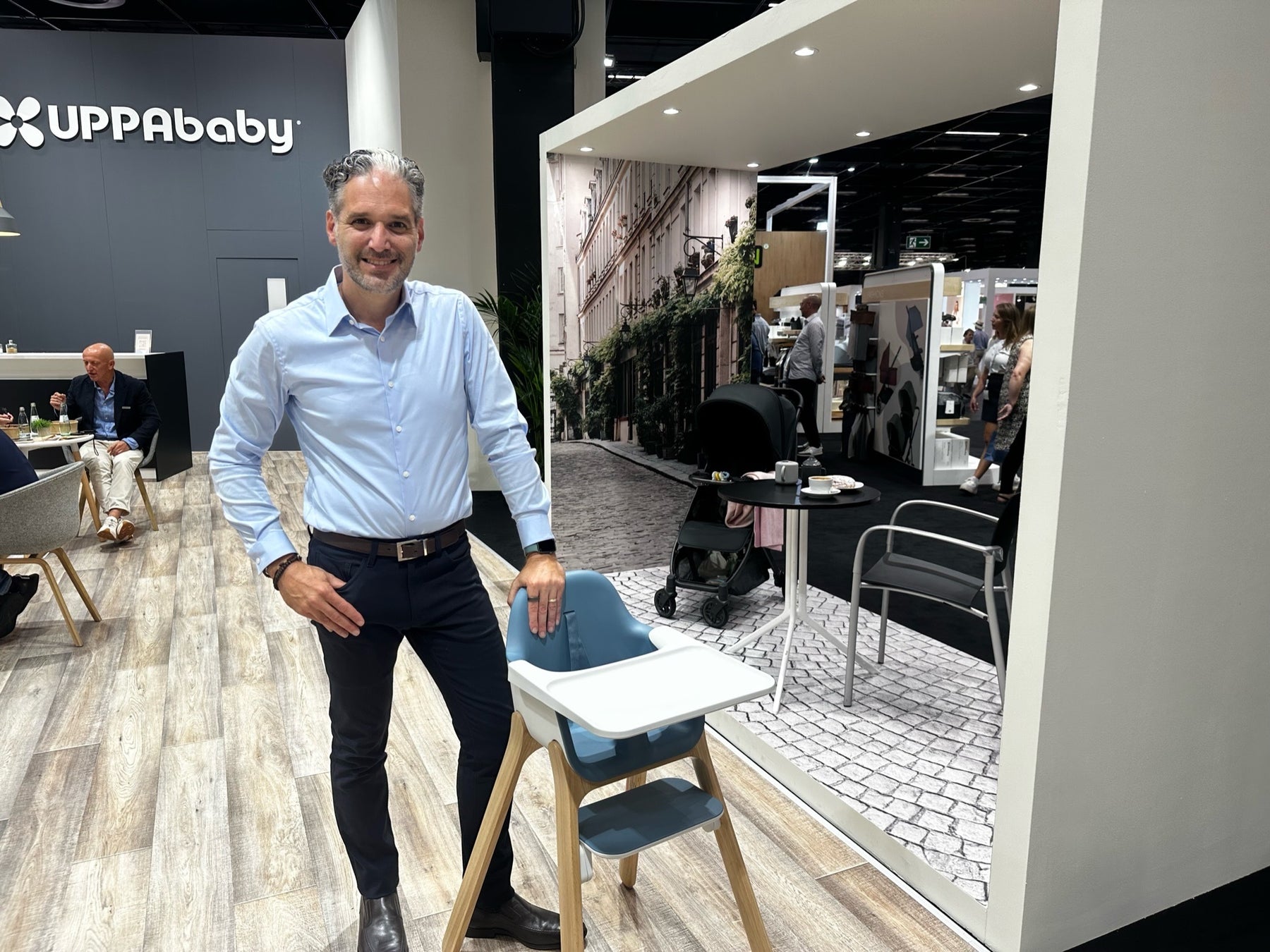 The UPPAbaby Ciro High Chair and Gear Expert Eli Gurock is standing next to it